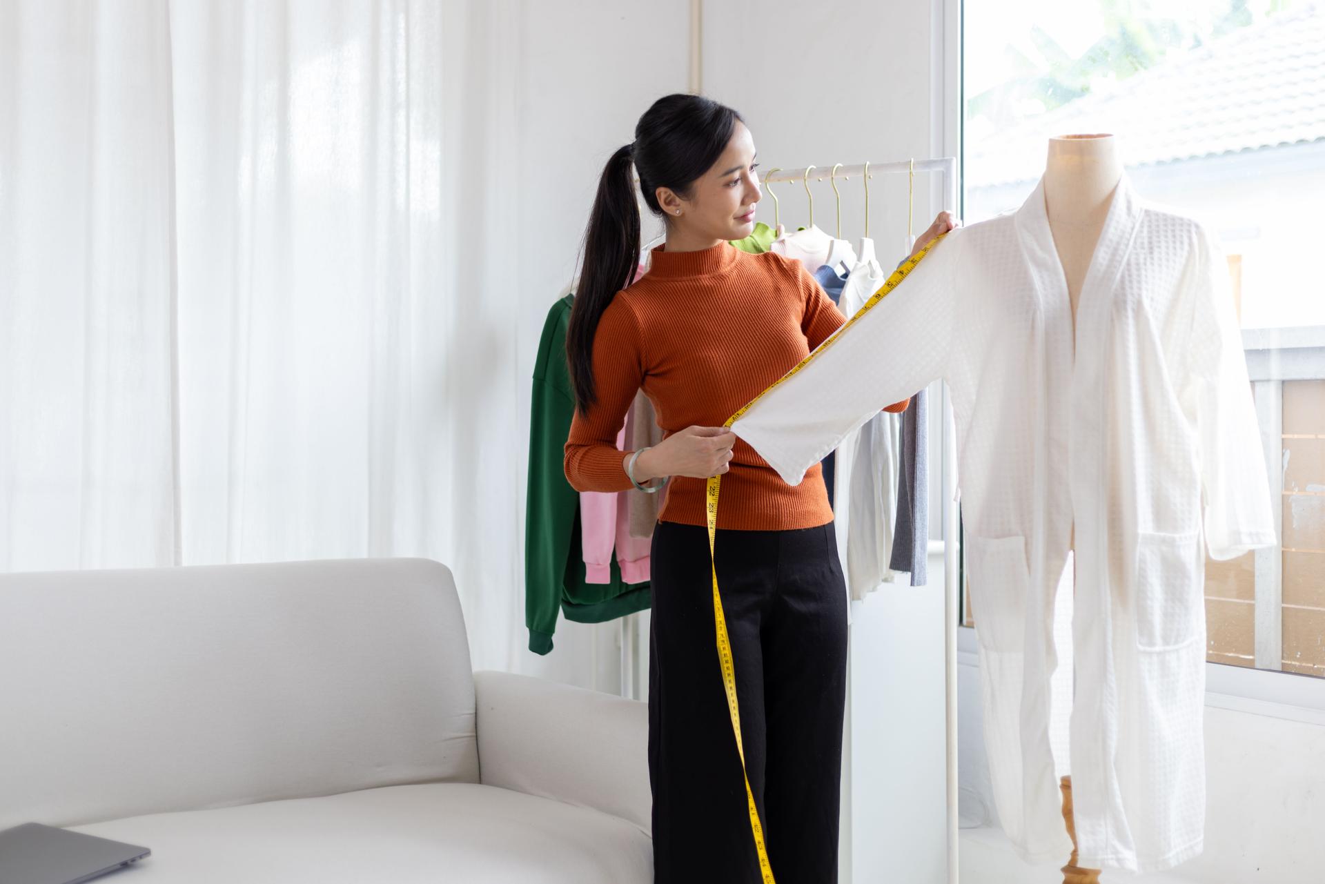 Portrait of a young Asian female entrepreneur starting an online clothing store.