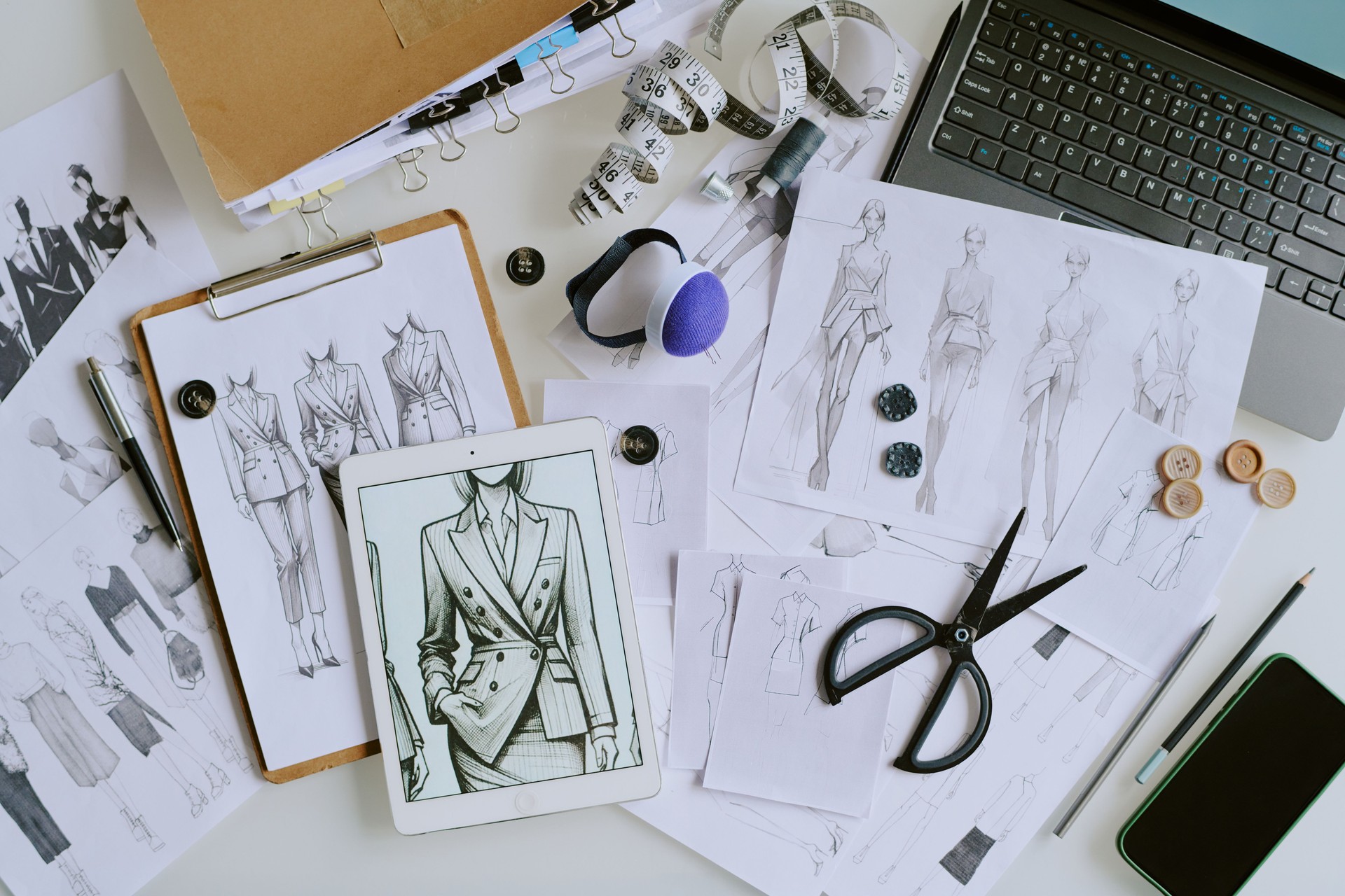 Laptop and Sketches on Table